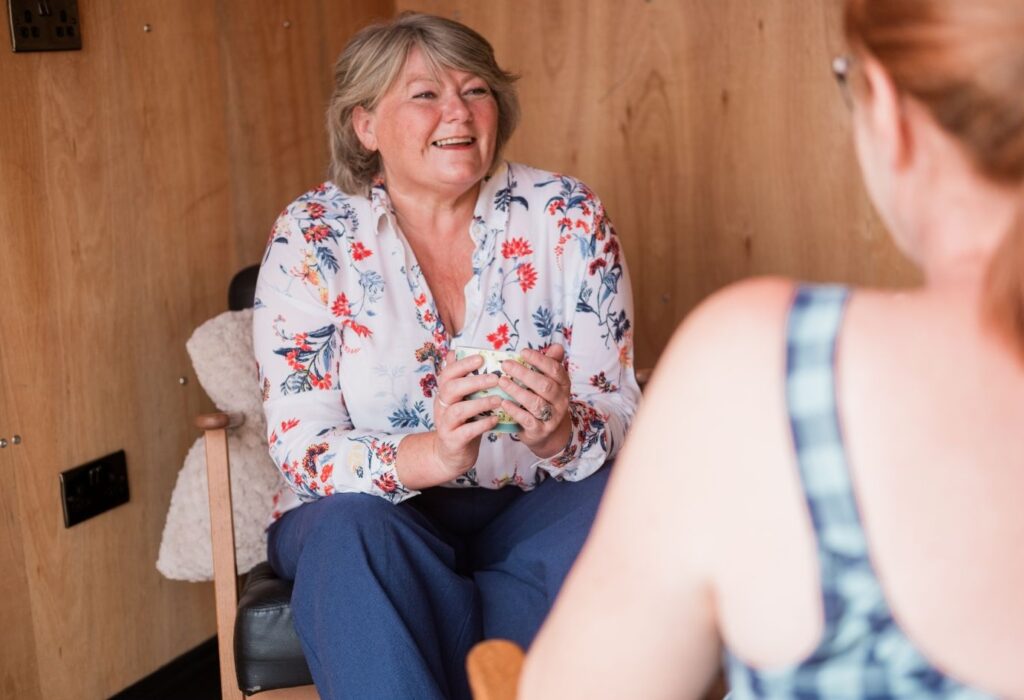Lynne Jones supporting a client in her community hub, providing a safe space for personal growth