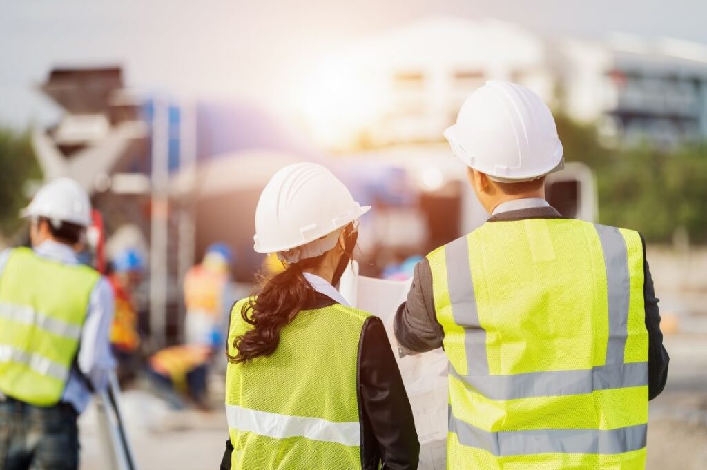 Man and woman on a construction site, representing workplace wellbeing in high-pressure environments