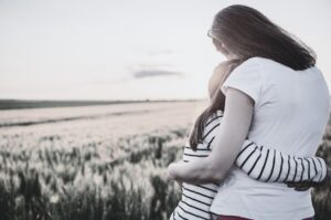 Mother hugging her daughter, representing comfort, emotional support, and healing through grief