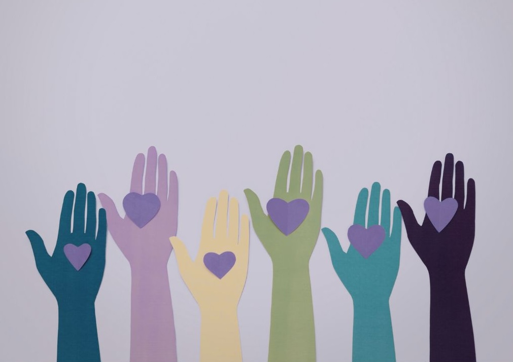 Illustration of hands holding hearts, representing care, compassion, and emotional support