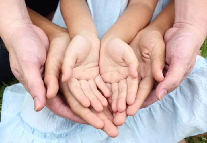 adult holding children's hands